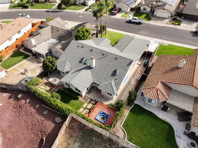 an aerial view of a house with a yard