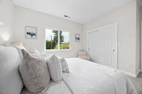 a bedroom with a large bed and a window