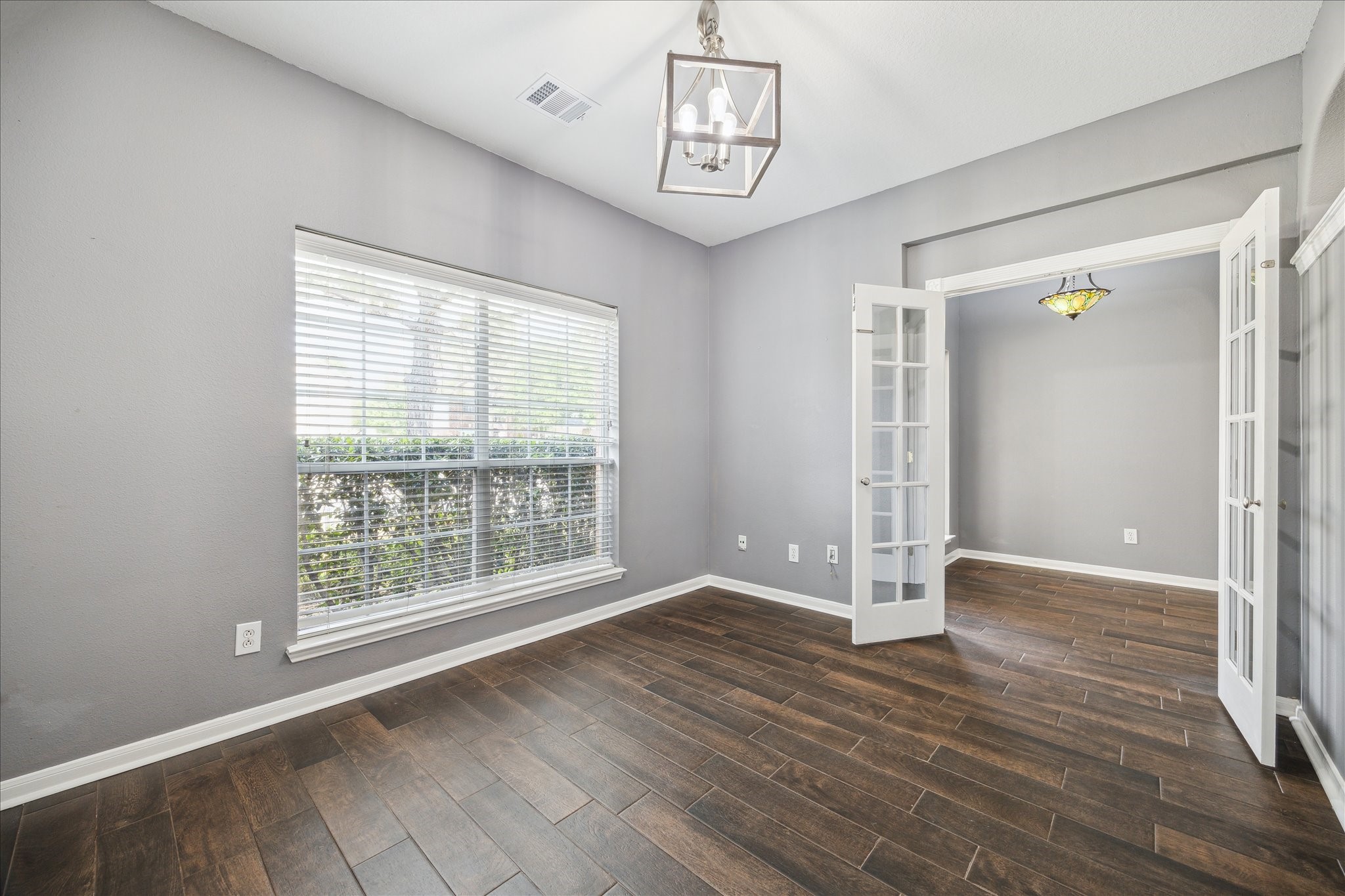 20910 Sandy Briar Court Spring, TX 77379 - Photo 5 of 28 a view of an empty room with wooden floor and a window