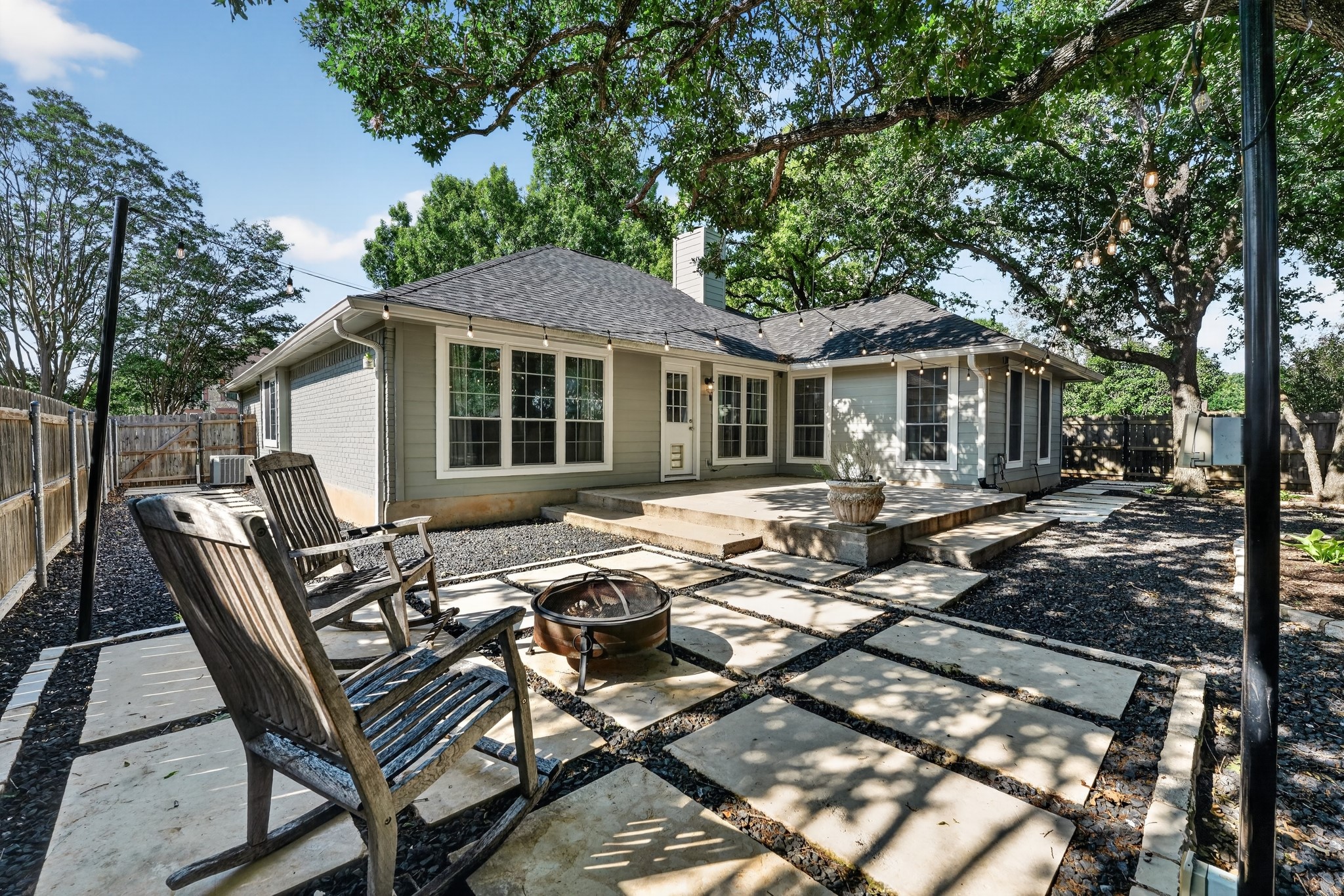 1811 Old Mill Road Cedar Park, TX 78613 - Photo 33 of 39 An inviting backyard oasis offers a spacious patio, a fire pit, and ample shade from mature trees.
