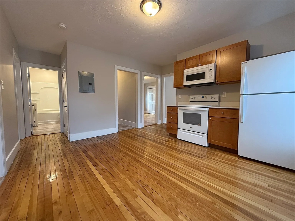 1301 Main Street, Unit 2 Worcester, MA 01603 - Photo 12 of 15 a view of kitchen with wooden floor electronic appliances and window