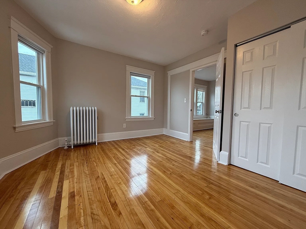 1301 Main Street, Unit 2 Worcester, MA 01603 - Photo 13 of 15 a view of empty room with wooden floor and fan