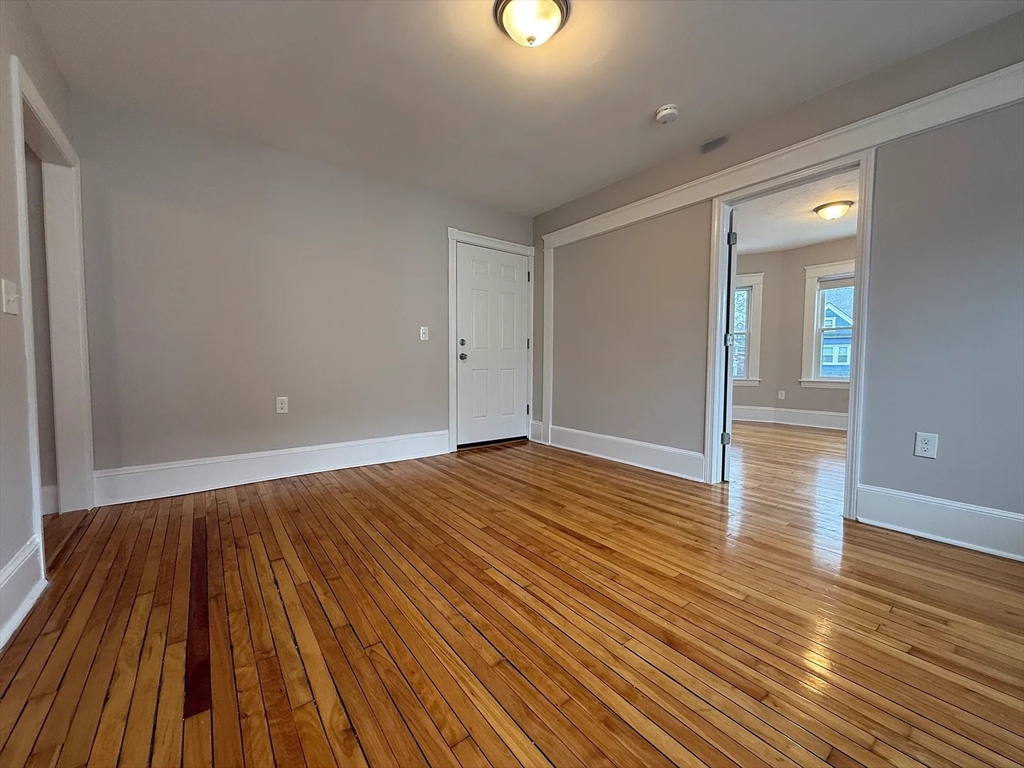 1301 Main Street, Unit 2 Worcester, MA 01603 - Photo 14 of 15 wooden floor in an empty room with a workspace