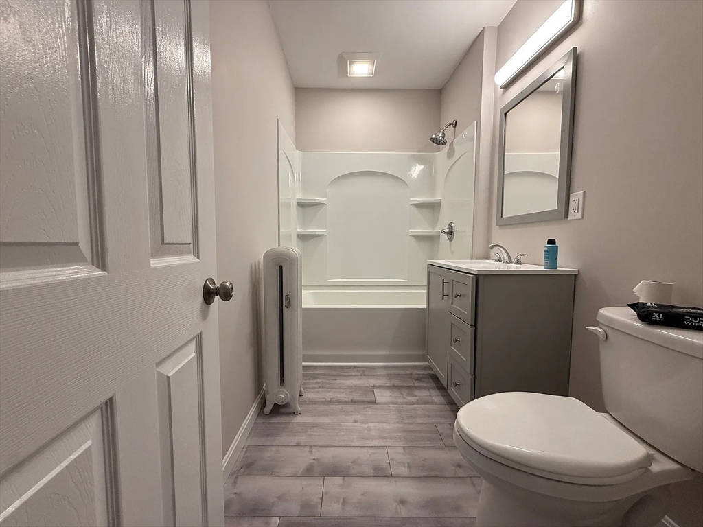1301 Main Street, Unit 2 Worcester, MA 01603 - Photo 15 of 15 a bathroom with a toilet a sink and mirror