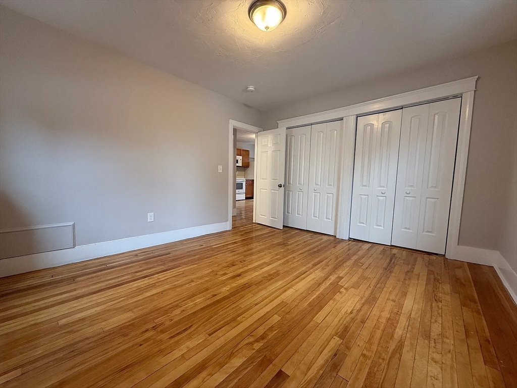 1301 Main Street, Unit 2 Worcester, MA 01603 - Photo 7 of 15 a view of an empty room and wooden floor