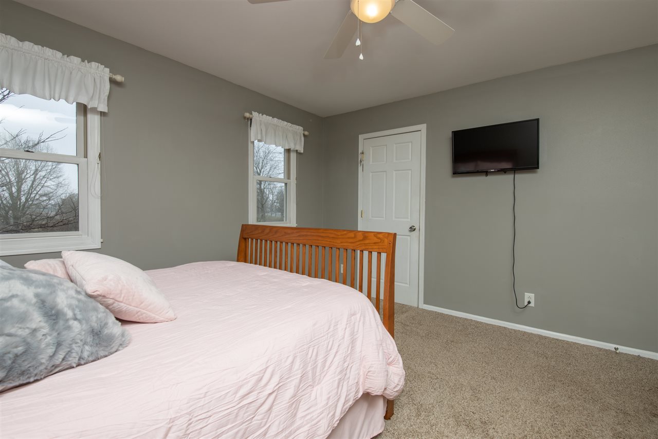 12410 Beaverton Road Poplar Grove, IL 61065 - Photo 23 of 37 a bedroom with a bed and a flat screen tv