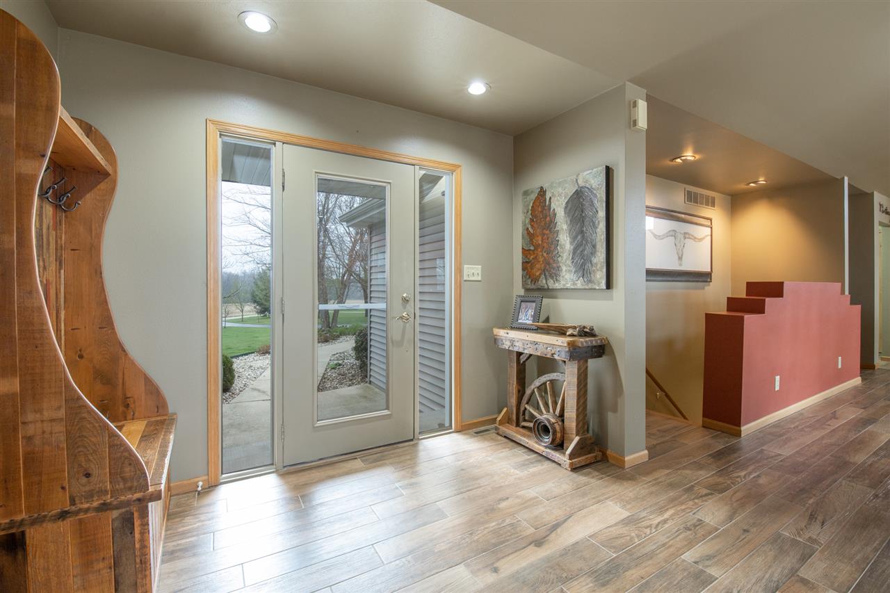 12410 Beaverton Road Poplar Grove, IL 61065 - Photo 4 of 37 a view of a hallway with wooden floor and windows