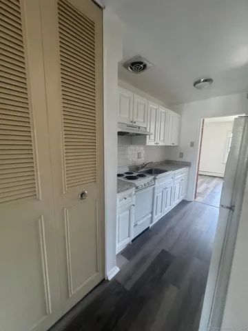 a kitchen with a sink a refrigerator a stove and cabinets