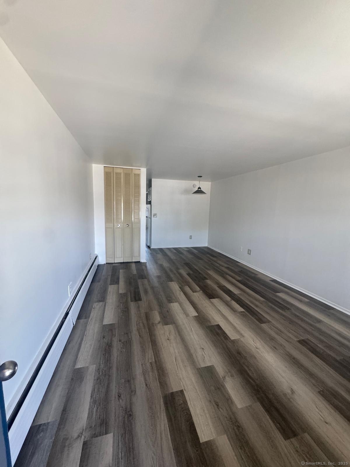 169 Birdseye Street, Unit C7 Bridgeport, CT 06604 - Photo 3 of 4 a view of empty room with wooden floor