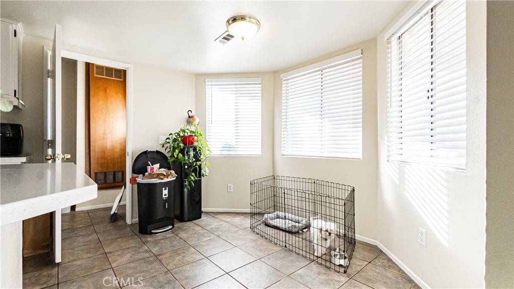 22993 Eyota Road Apple Valley, CA 92308 - Photo 11 of 38 a living room with furniture and a window