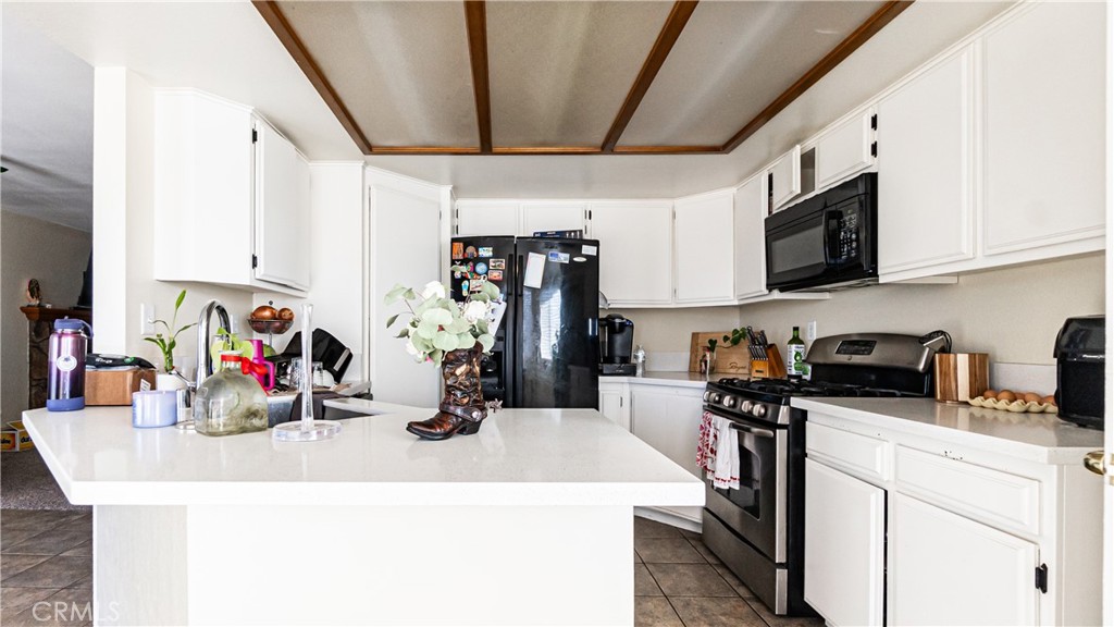 22993 Eyota Road Apple Valley, CA 92308 - Photo 12 of 38 a view of a kitchen with sink dishwasher and microwave