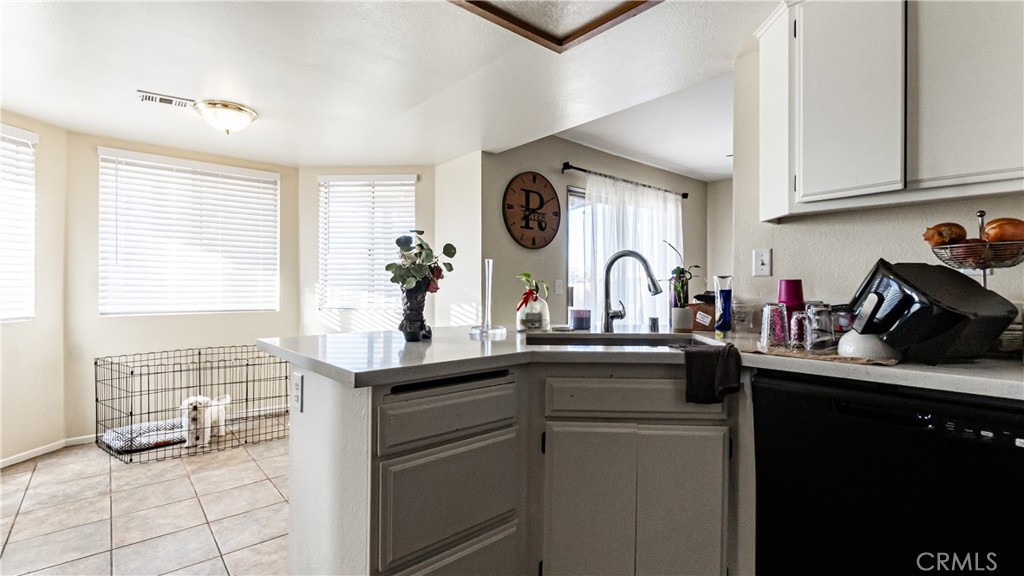 22993 Eyota Road Apple Valley, CA 92308 - Photo 15 of 38 a kitchen with stainless steel appliances granite countertop a sink and cabinets
