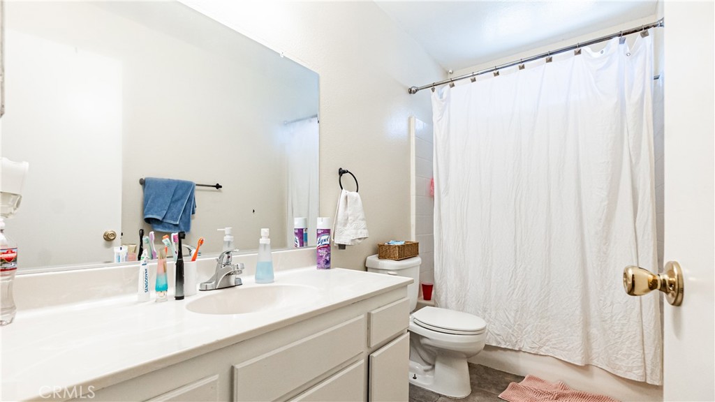 22993 Eyota Road Apple Valley, CA 92308 - Photo 20 of 38 a bathroom with a sink a toilet and shower