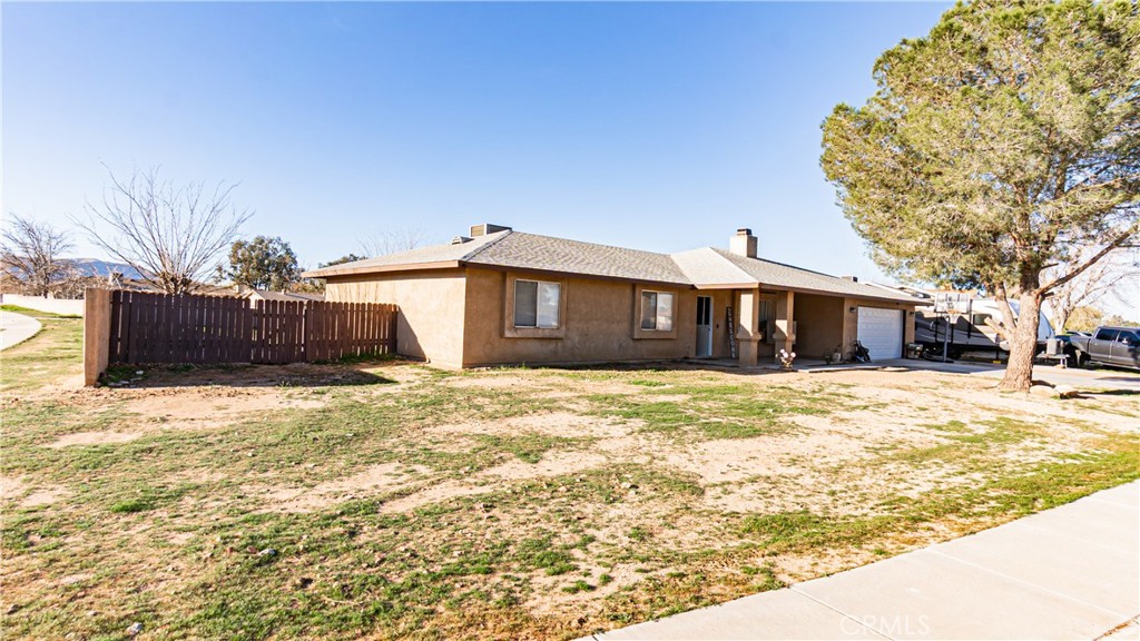 22993 Eyota Road Apple Valley, CA 92308 - Photo 2 of 38 a front view of a house with a yard covered in snow