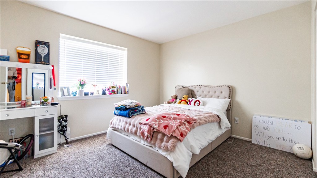 22993 Eyota Road Apple Valley, CA 92308 - Photo 23 of 38 a bedroom with a bed and a table