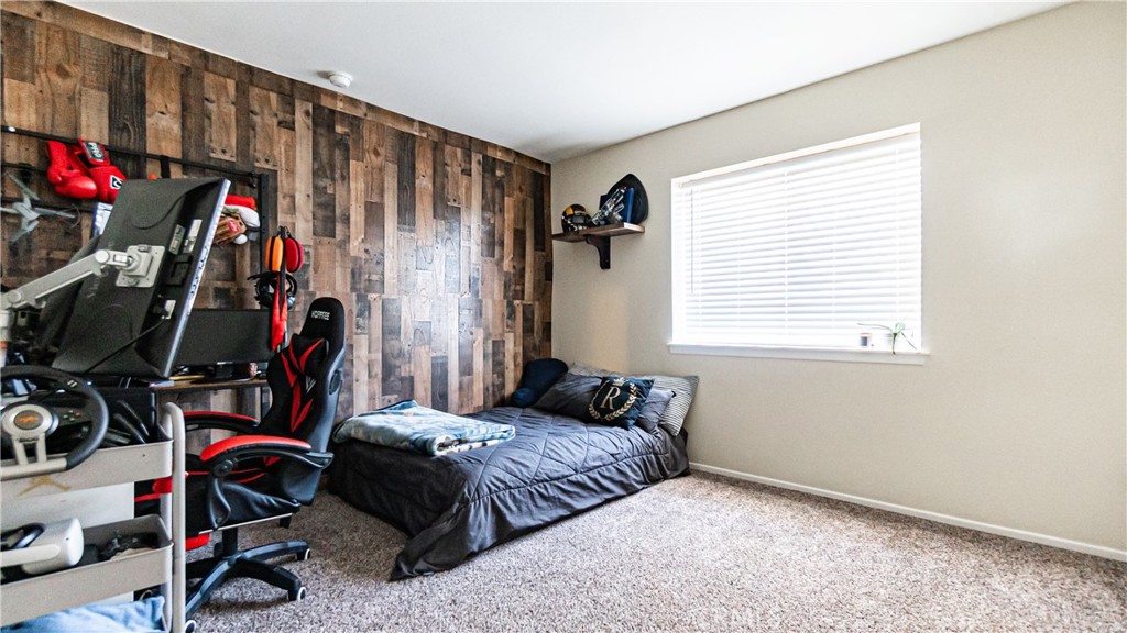 22993 Eyota Road Apple Valley, CA 92308 - Photo 25 of 38 a bedroom with a bed a closet and a window