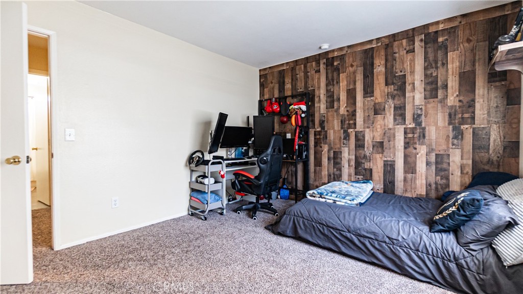 22993 Eyota Road Apple Valley, CA 92308 - Photo 26 of 38 a bed room with a bed and a desk