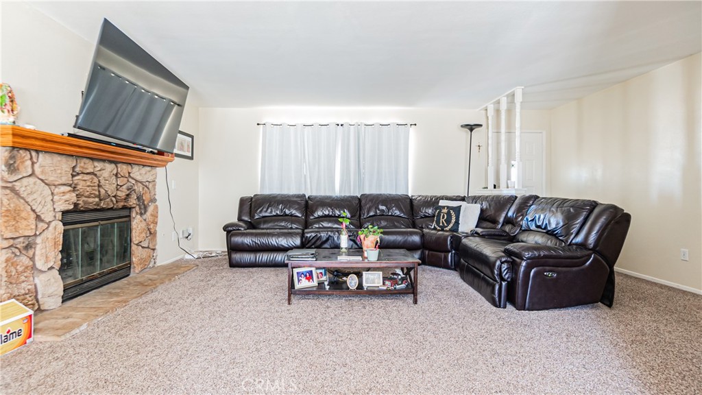 22993 Eyota Road Apple Valley, CA 92308 - Photo 6 of 38 a living room with furniture and a fireplace