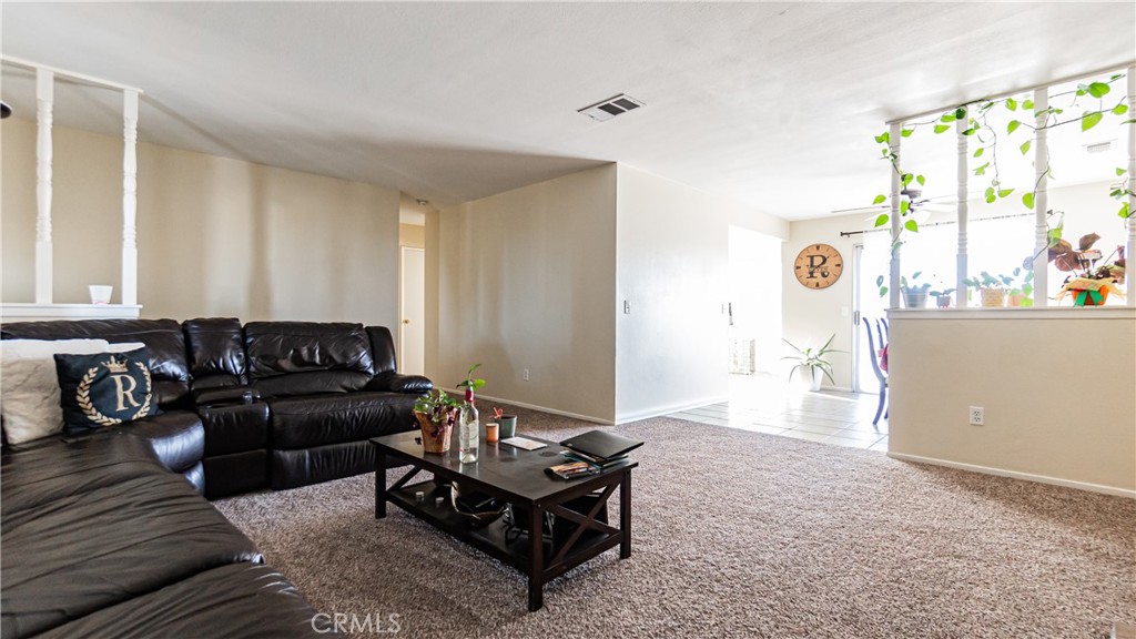 22993 Eyota Road Apple Valley, CA 92308 - Photo 7 of 38 a living room with furniture and a large window