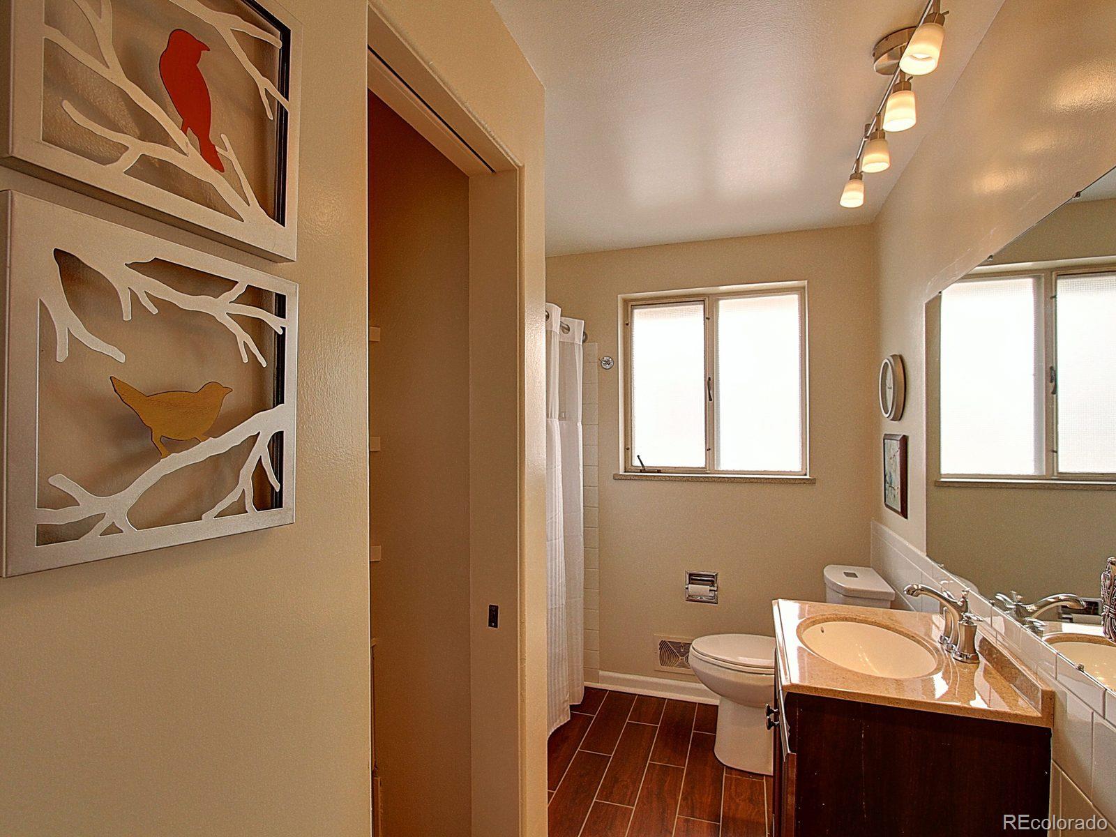 3840 Pierce Street Wheat Ridge, CO 80033 - Photo 16 of 32 a bathroom with a sink and a mirror
