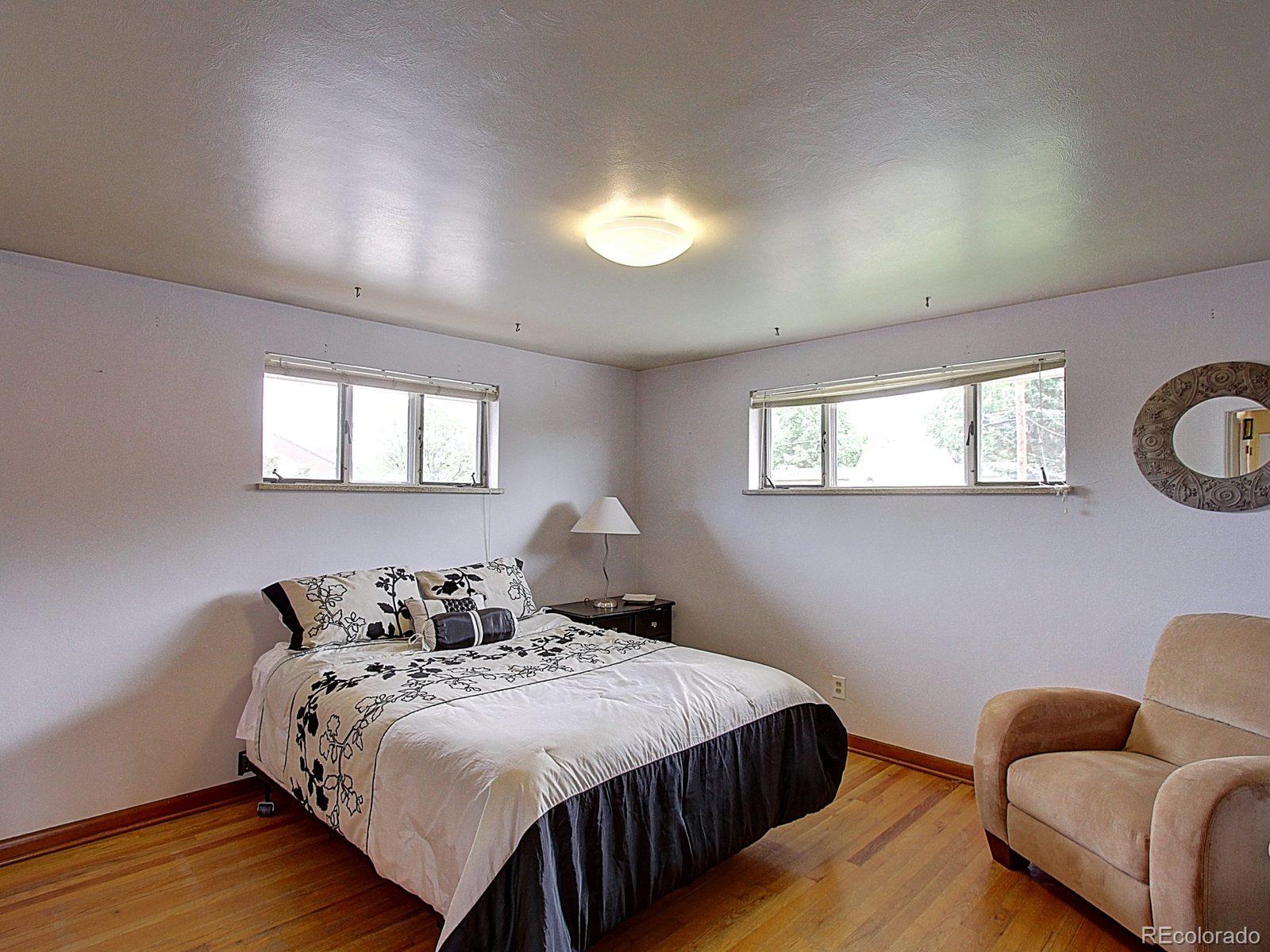 3840 Pierce Street Wheat Ridge, CO 80033 - Photo 18 of 32 a bedroom with bed and window