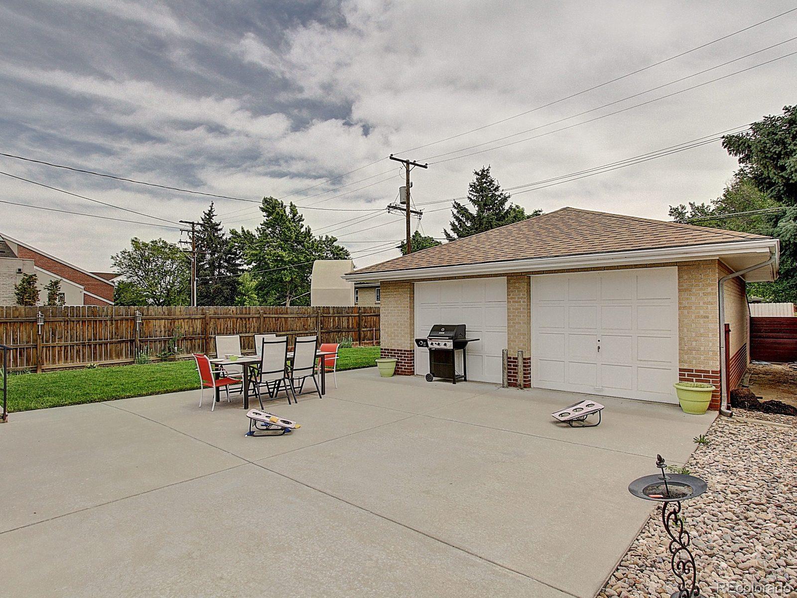 3840 Pierce Street Wheat Ridge, CO 80033 - Photo 25 of 32 a view of a patio with table and chairs with wooden fence