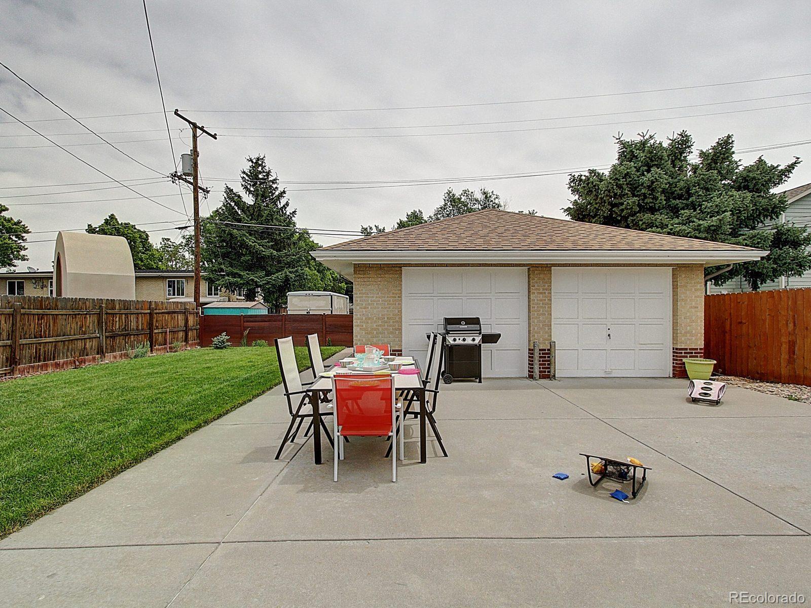 3840 Pierce Street Wheat Ridge, CO 80033 - Photo 29 of 32 a backyard of a house with table and chairs