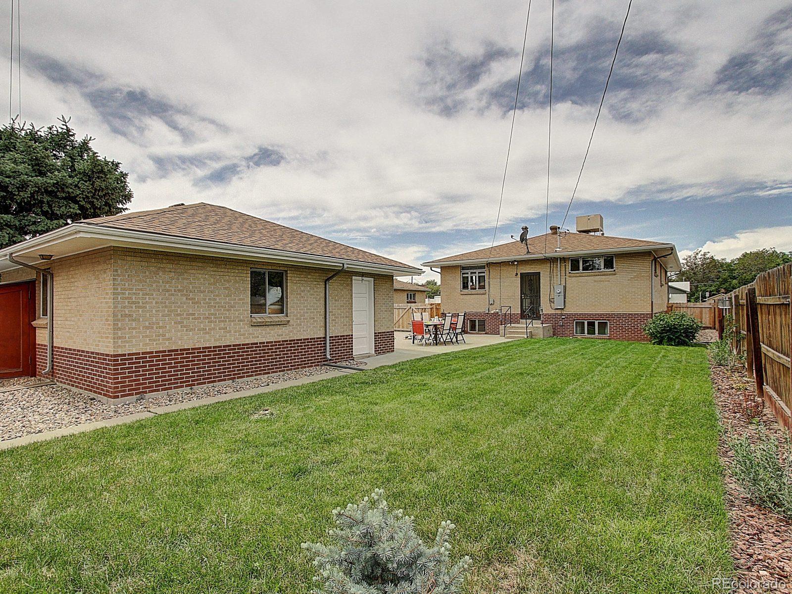 3840 Pierce Street Wheat Ridge, CO 80033 - Photo 30 of 32 a front view of house with yard and green space