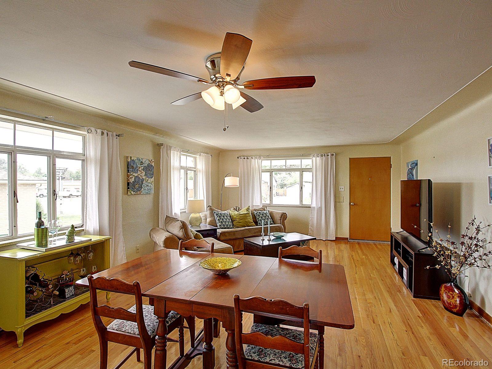 3840 Pierce Street Wheat Ridge, CO 80033 - Photo 5 of 32 a view of a dining room with furniture window and wooden floor