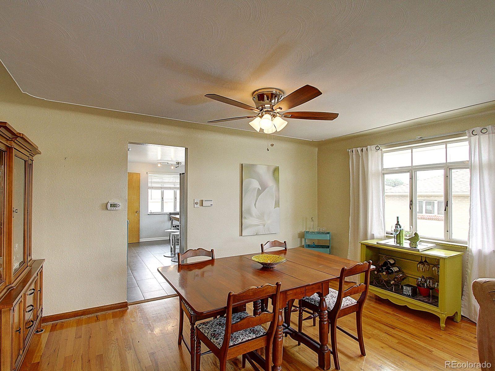 3840 Pierce Street Wheat Ridge, CO 80033 - Photo 8 of 32 a view of a dining room with furniture window and wooden floor
