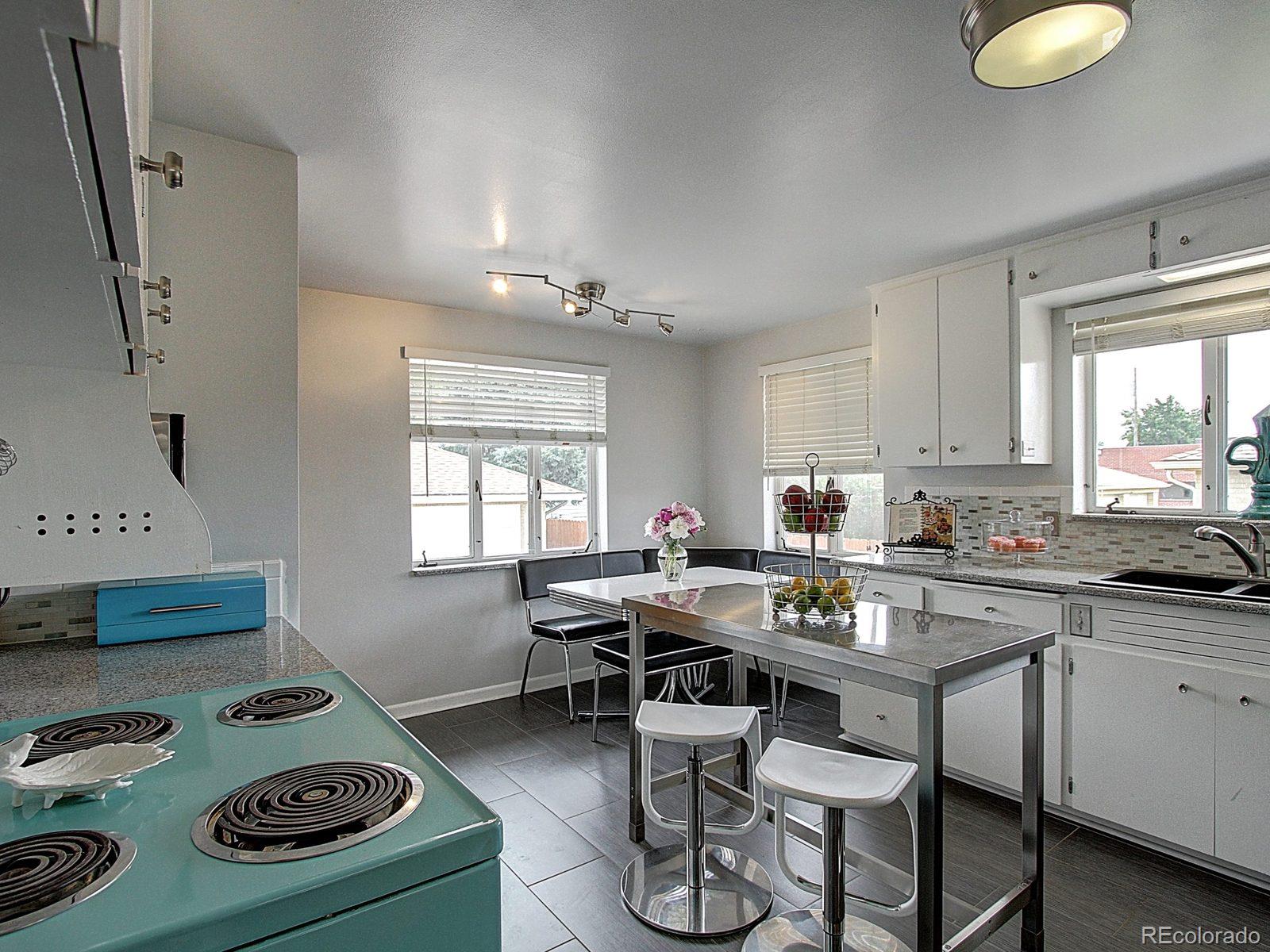 3840 Pierce Street Wheat Ridge, CO 80033 - Photo 9 of 32 a kitchen with a table and chairs in it
