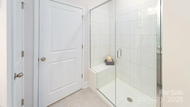 a bathroom with a glass shower door