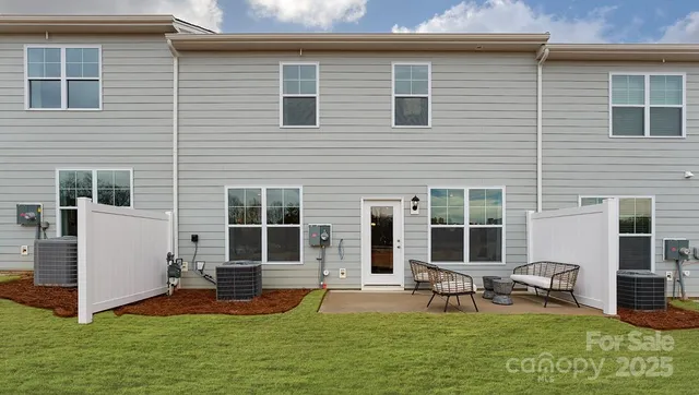 a view of a house with backyard porch and sitting area