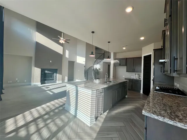 a large kitchen with stainless steel appliances kitchen island granite countertop a large counter top and stove