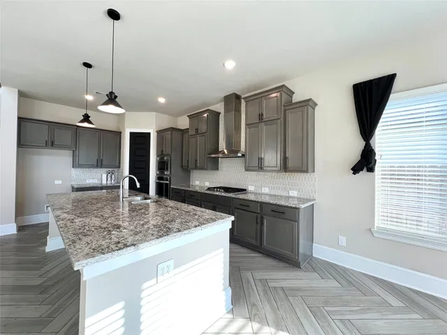 a kitchen with stainless steel appliances granite countertop sink stove and granite counter top