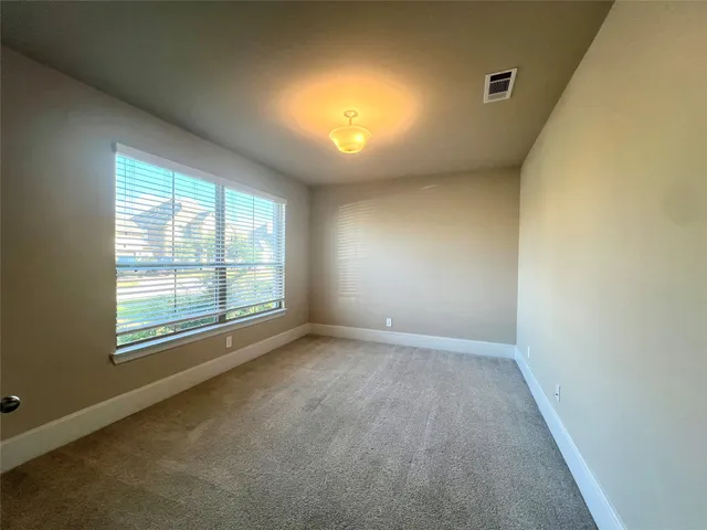 an empty room with a empty space and windows