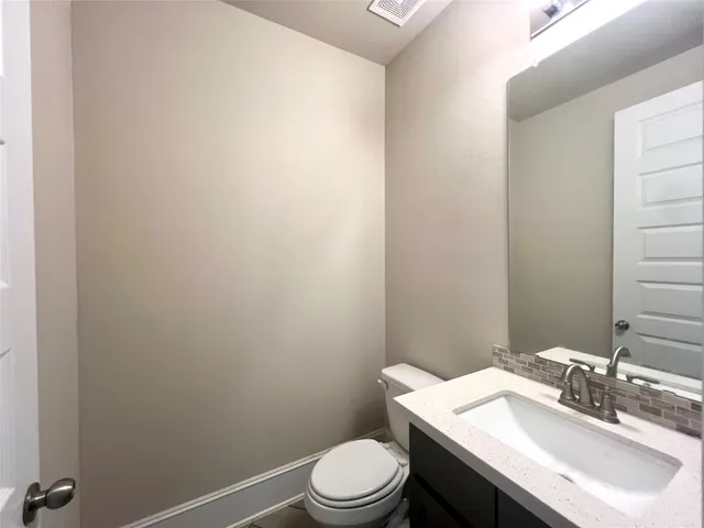 a bathroom with a sink a toilet and mirror