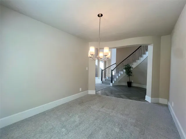 a view of an empty room with stairs
