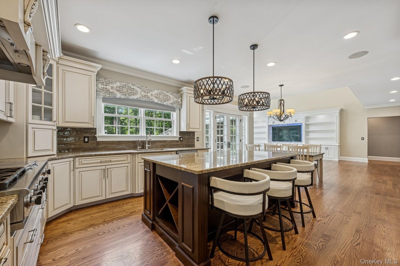 33 Bacon Road St. James, NY 11780 - Photo 11 of 48 a kitchen with granite countertop a stove a sink a dining table and chairs