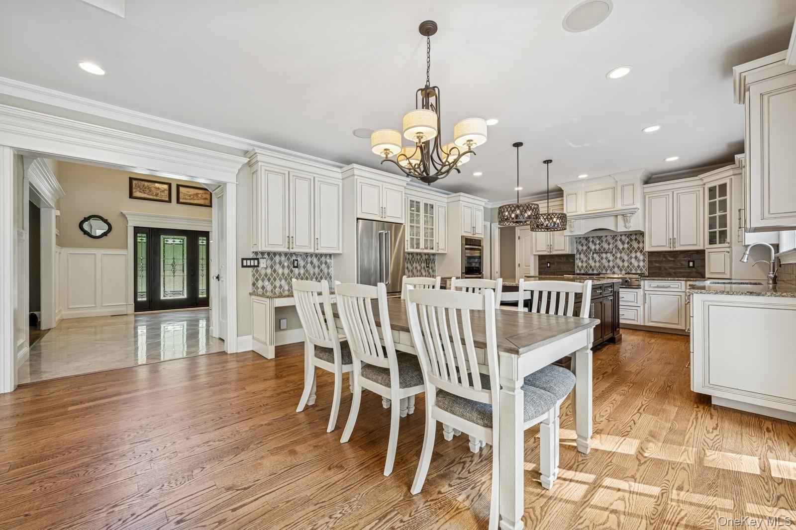 33 Bacon Road St. James, NY 11780 - Photo 17 of 48 a view of a dining room and livingroom with furniture wooden floor a chandelier