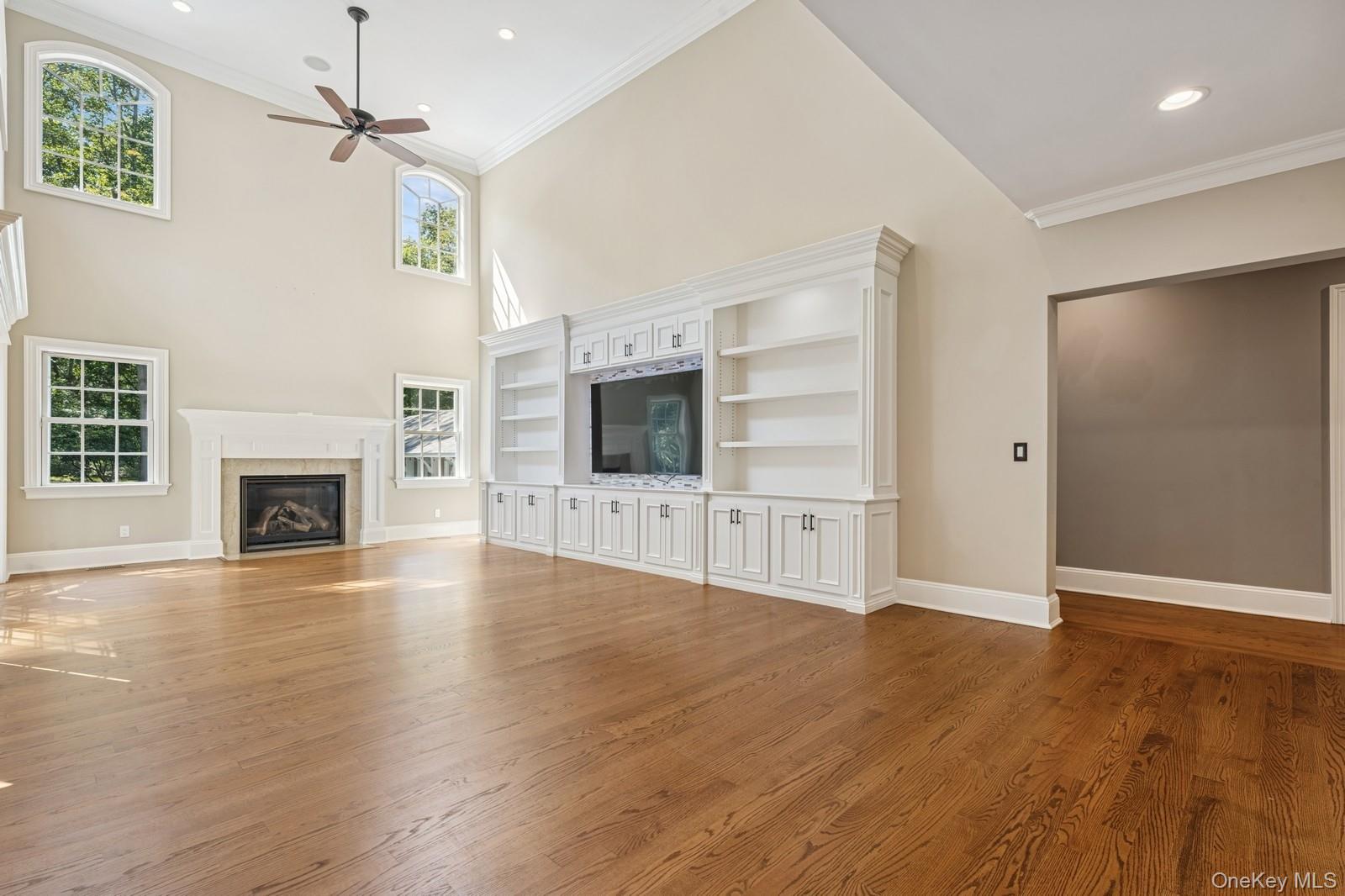 33 Bacon Road St. James, NY 11780 - Photo 18 of 48 an empty room with wooden floor fireplace and windows