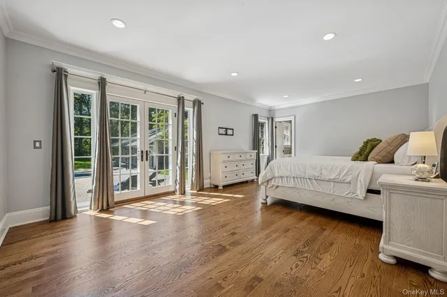 a spacious bedroom with a bed and a large window