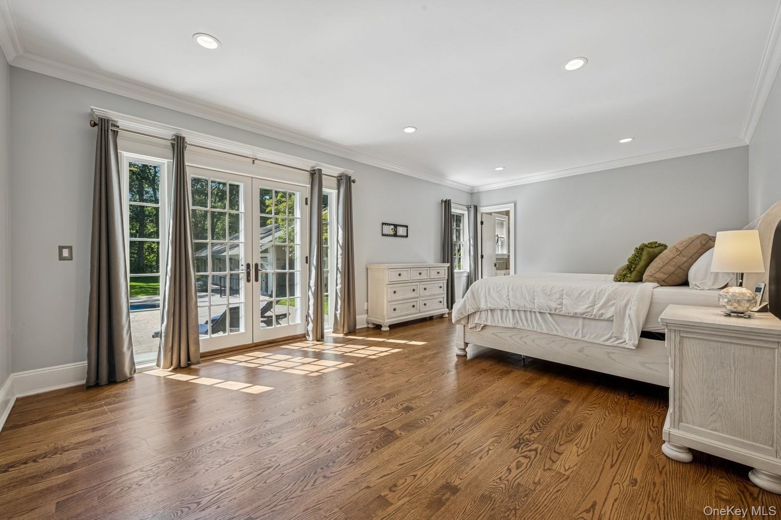 33 Bacon Road St. James, NY 11780 - Photo 21 of 48 a spacious bedroom with a bed and a large window