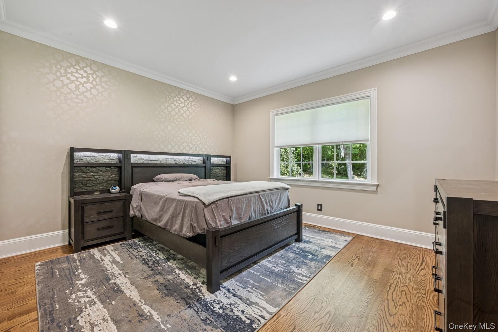 33 Bacon Road St. James, NY 11780 - Photo 23 of 48 a bed sitting in a bedroom next to a window