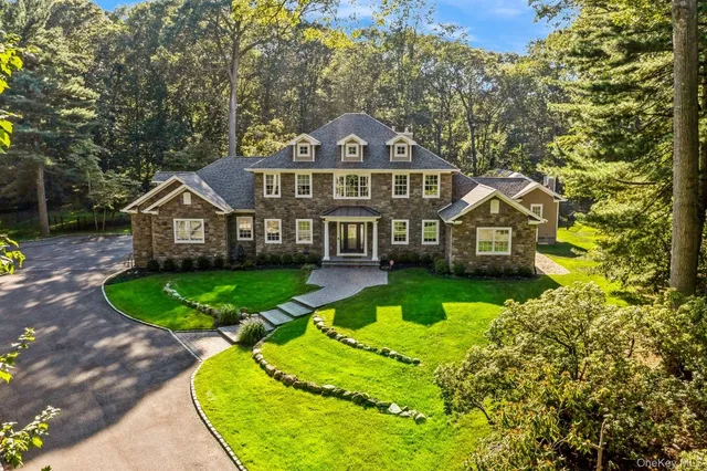 a front view of a house with a yard table and chairs