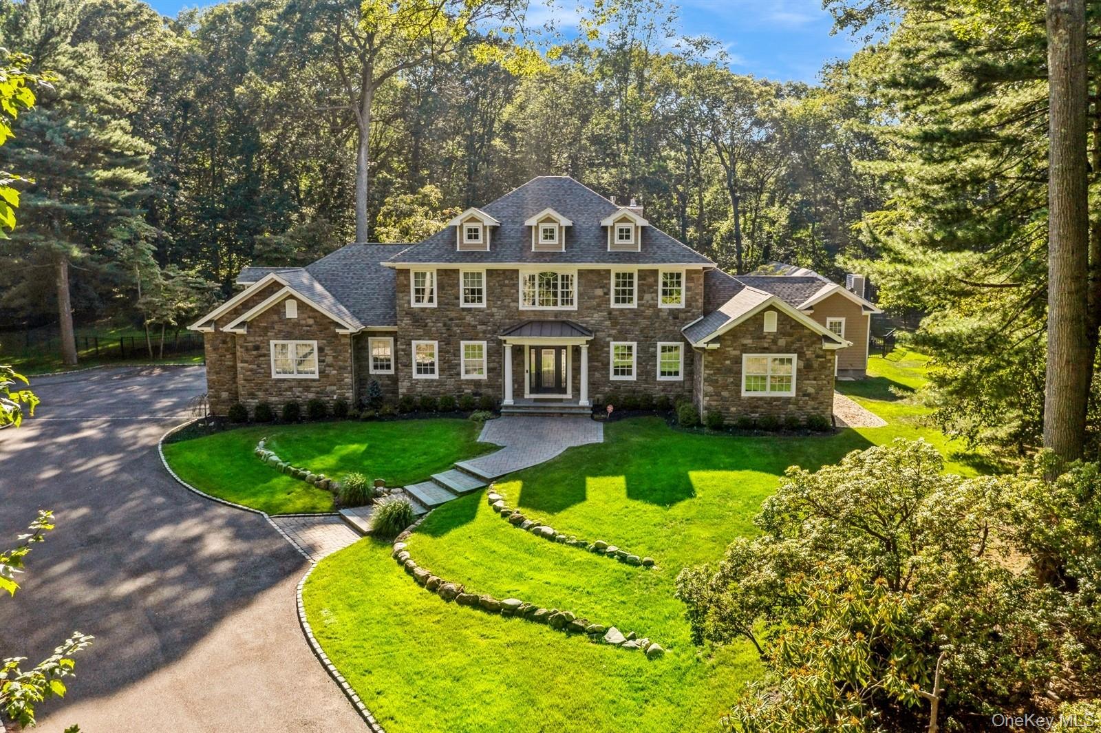 33 Bacon Road St. James, NY 11780 - Photo 3 of 48 a front view of a house with a yard table and chairs