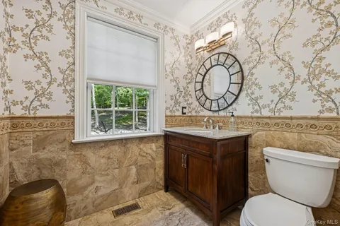 a bathroom with a toilet sink and mirror