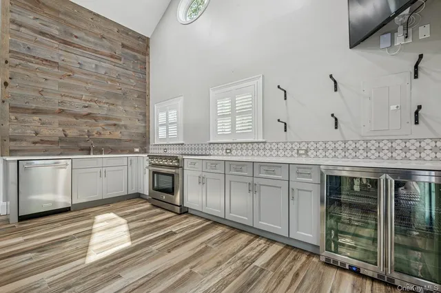 a kitchen with granite countertop a stove cabinets and wooden floor