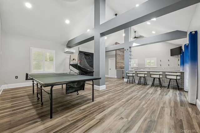 a living room with furniture a table and kitchen view