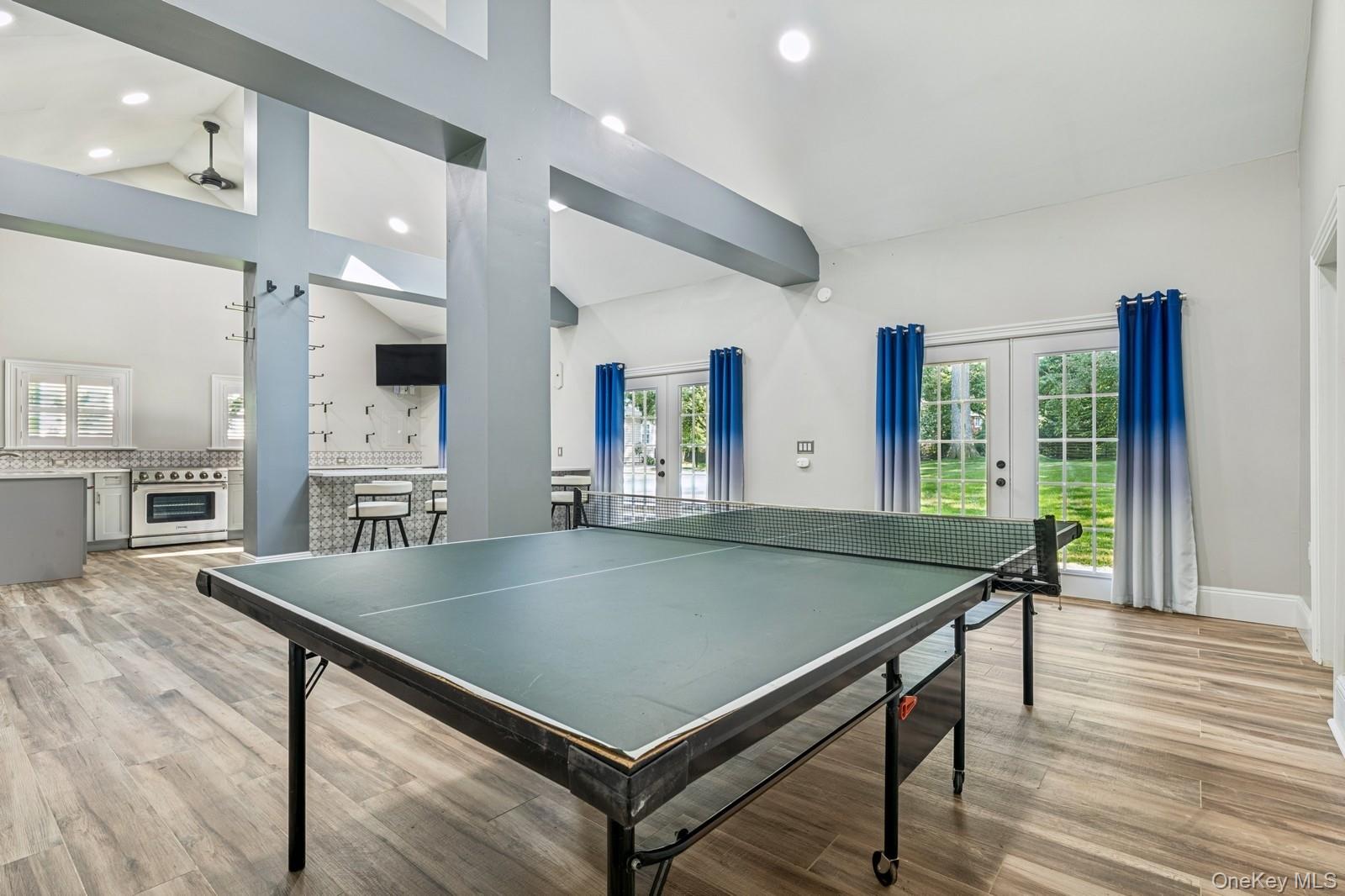 33 Bacon Road St. James, NY 11780 - Photo 37 of 48 an open kitchen with stainless steel appliances a dining table chairs and wooden floor